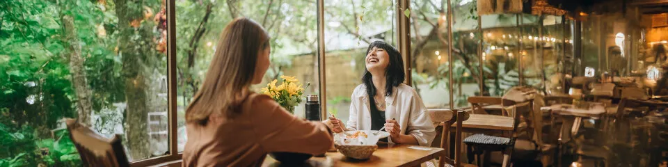 Imagem mostra duas mulheres se alimentando em um restaurante
